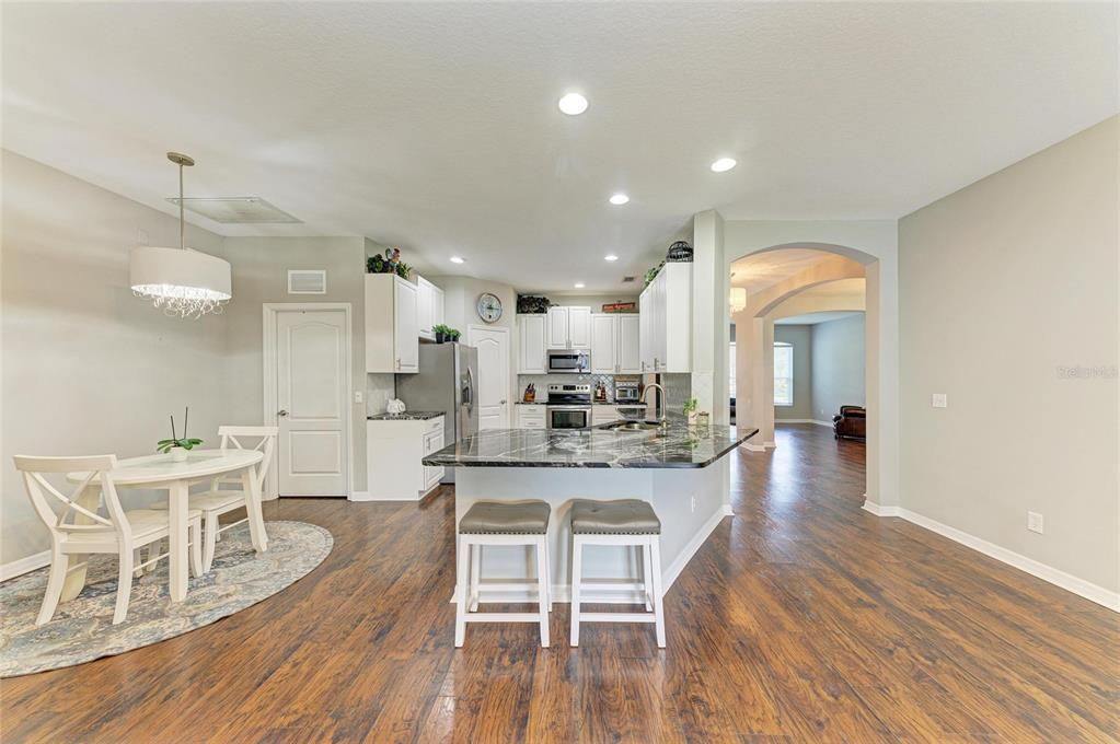 Chandelier, Dining room, Interior, Kitchen, Pendant Lights, Recessed Lighting, Stainless Steel Appliances, Wood Texture Flooring