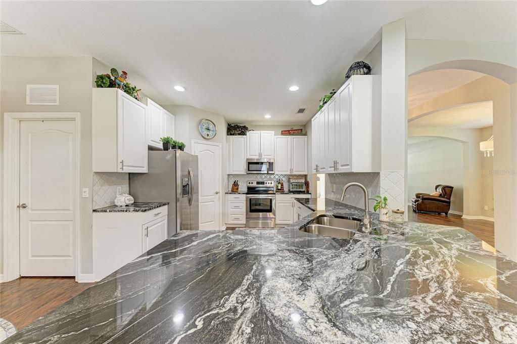 Fireplace, Interior, Kitchen, Recessed Lighting, Stainless Steel Appliances, Wood Texture Flooring