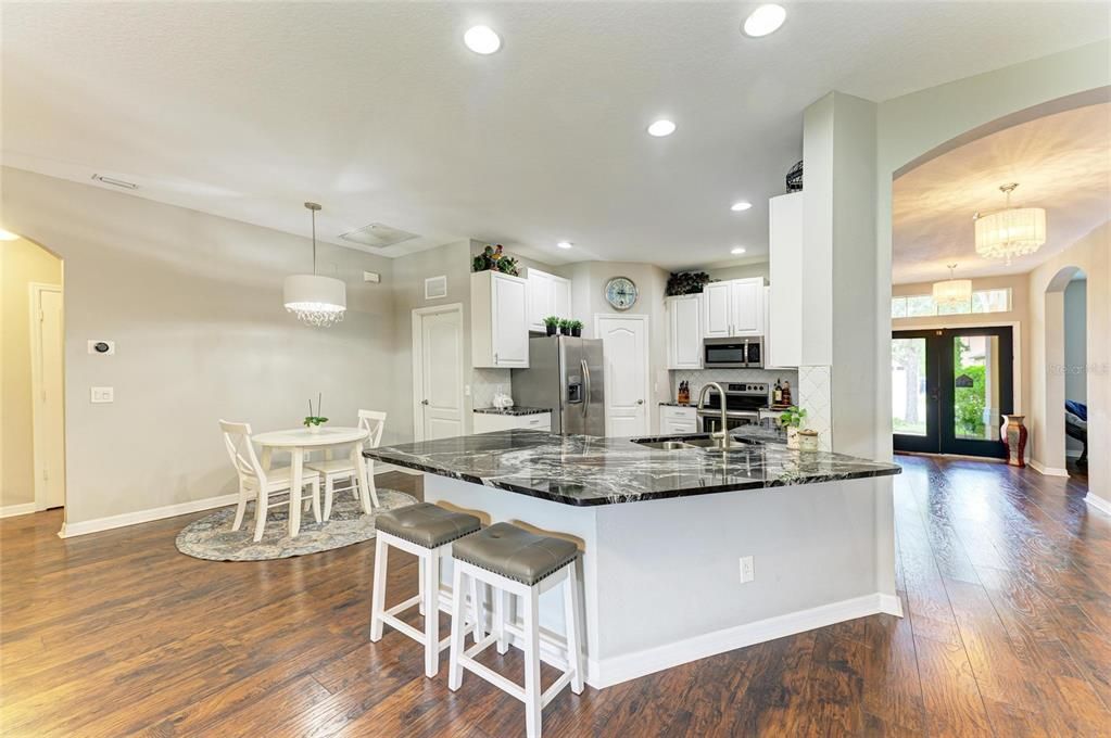 Chandelier, Dining room, Interior, Kitchen, Pendant Lights, Recessed Lighting, Stainless Steel Appliances, Wood Texture Flooring