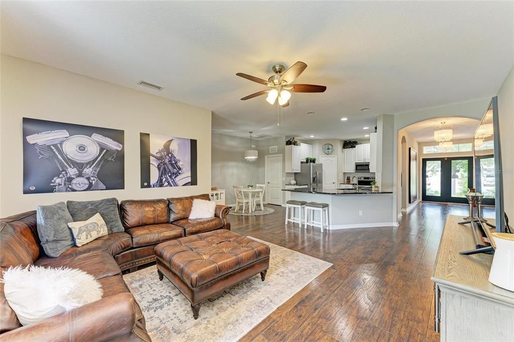 Chandelier, Dining room, Interior, Kitchen, Living room, Pendant Lights, Recessed Lighting, Stainless Steel Appliances, Wood Texture Flooring