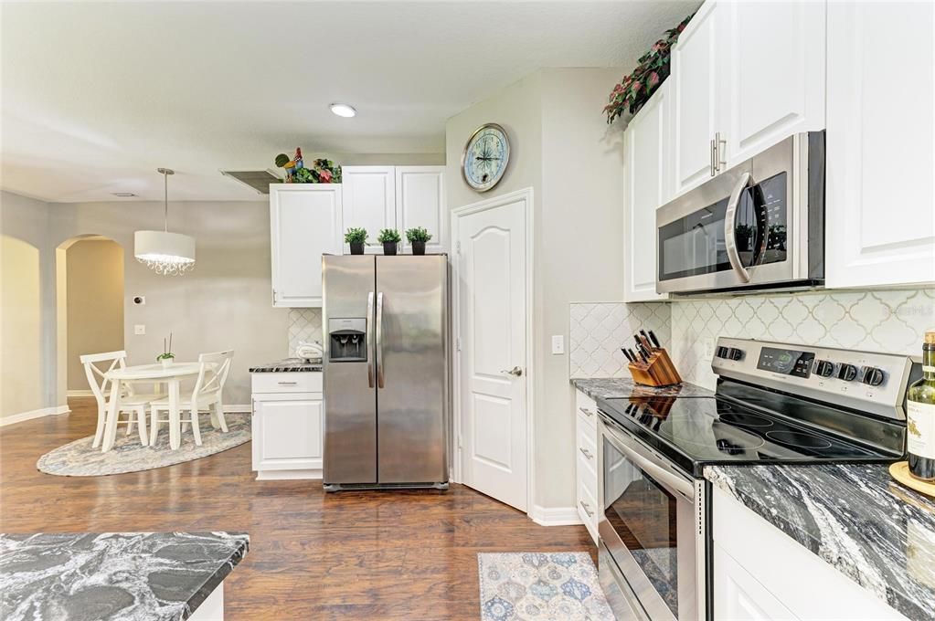 Dining room, Interior, Kitchen, Pendant Lights, Recessed Lighting, Stainless Steel Appliances, Wood Texture Flooring