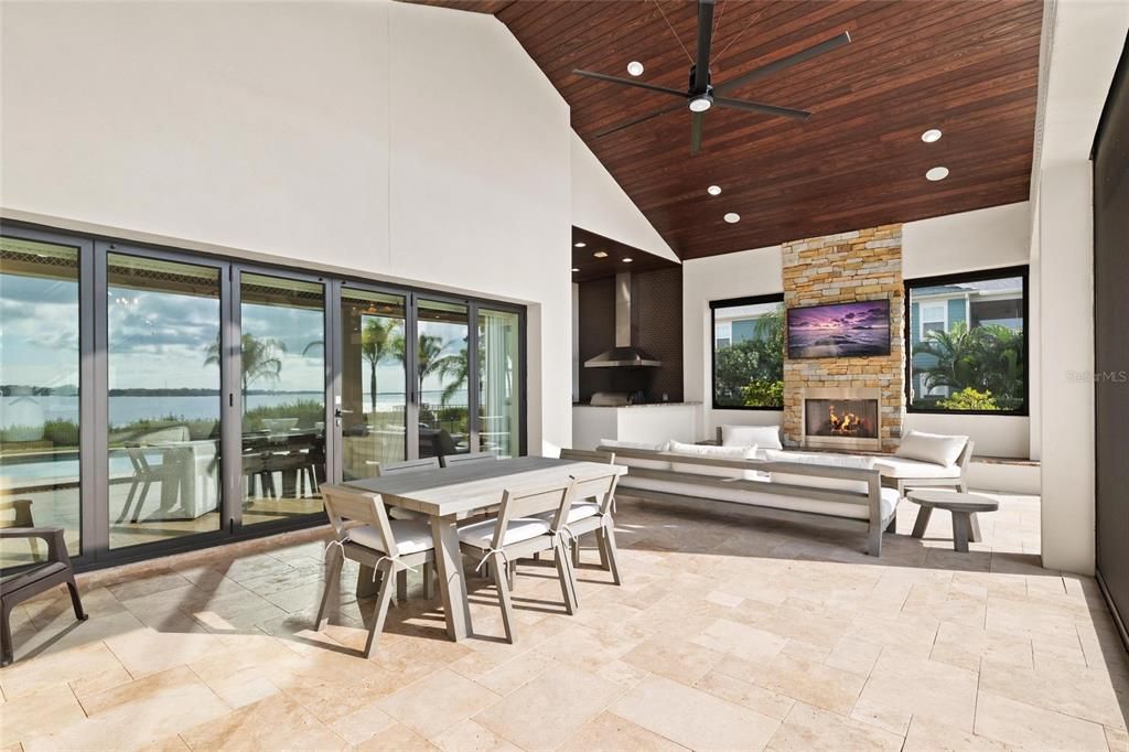 Dining room, Fireplace, Interior, Living room, Recessed Lighting, Stone Walls, Water, Wooden Ceilings