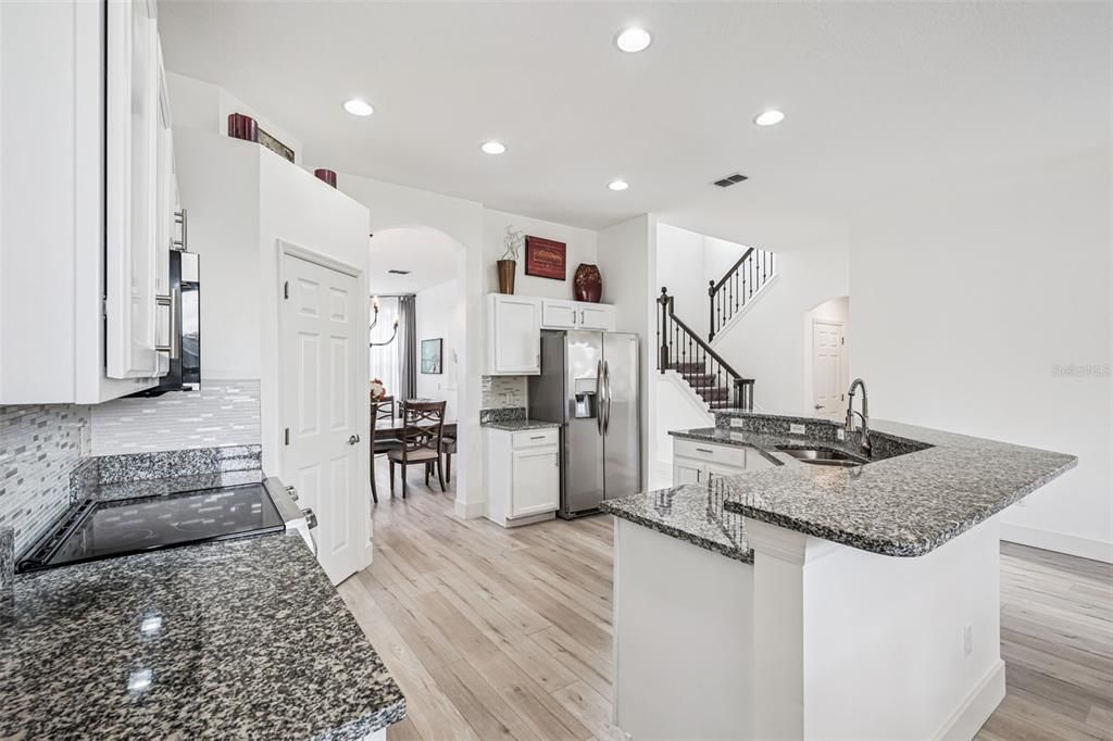 Dining room, Interior, Kitchen, Recessed Lighting, Stainless Steel Appliances, Wood Texture Flooring