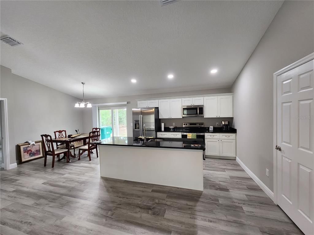 Dining room, Interior, Kitchen, Pendant Lights, Recessed Lighting, Stainless Steel Appliances, Wood Texture Flooring