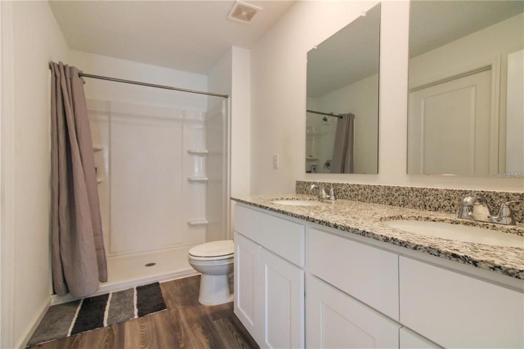 Bathroom, Dual Sink Vanities, Glass Shower, Interior, Wood Texture Flooring