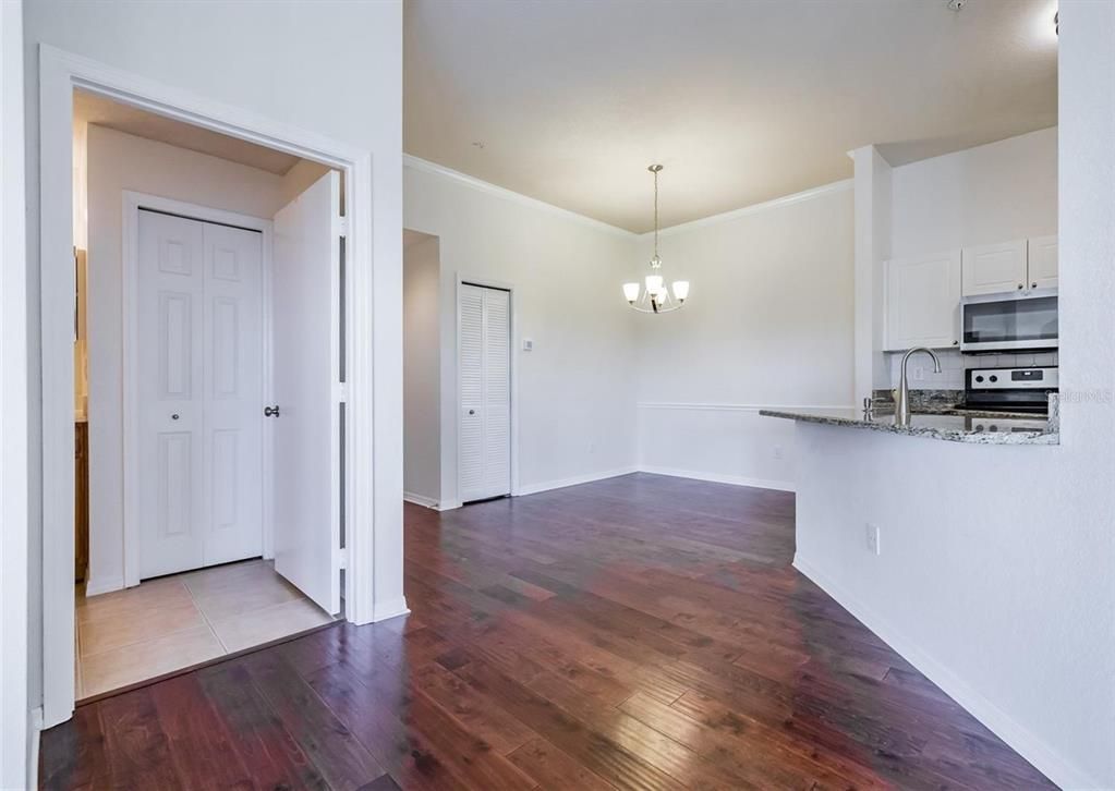 Chandelier, Empty room, Interior, Kitchen, Pendant Lights, Stainless Steel Appliances, Wood Texture Flooring