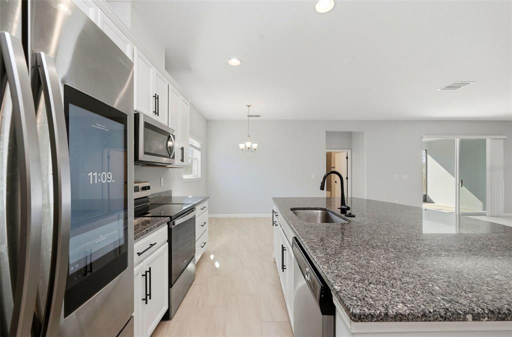 Chandelier, Interior, Kitchen, Pendant Lights, Recessed Lighting, Stainless Steel Appliances, Wood Texture Flooring