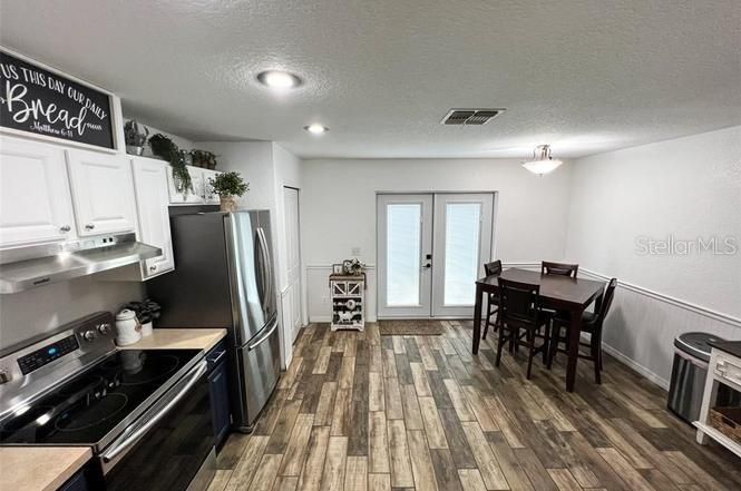 Dining room, Interior, Kitchen, Recessed Lighting, Stainless Steel Appliances, Wood Texture Flooring