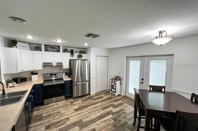 Dining room, Interior, Kitchen, Recessed Lighting, Stainless Steel Appliances, Wood Texture Flooring