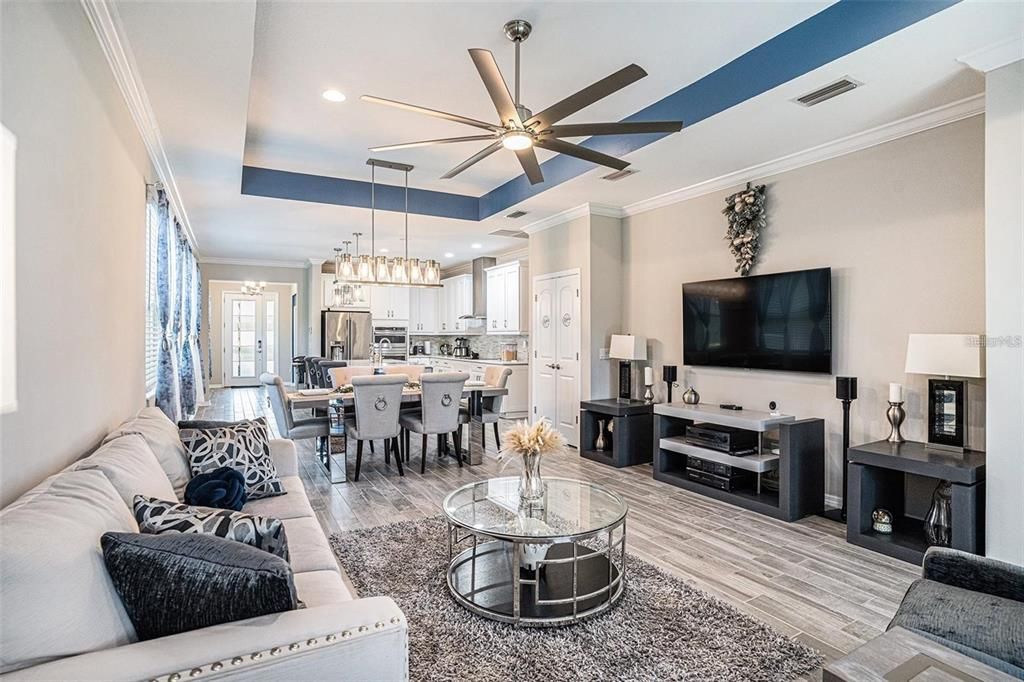 Chandelier, Dining room, Interior, Kitchen, Living room, Pendant Lights, Recessed Lighting, Stainless Steel Appliances, Wood Texture Flooring