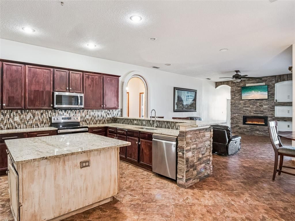 Fireplace, Interior, Kitchen, Recessed Lighting, Stainless Steel Appliances, Stone Walls