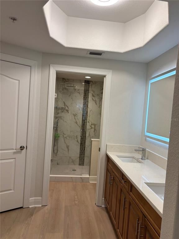 Bathroom, Dual Sink Vanities, Glass Shower, Interior, Marble Walls, Wood Texture Flooring