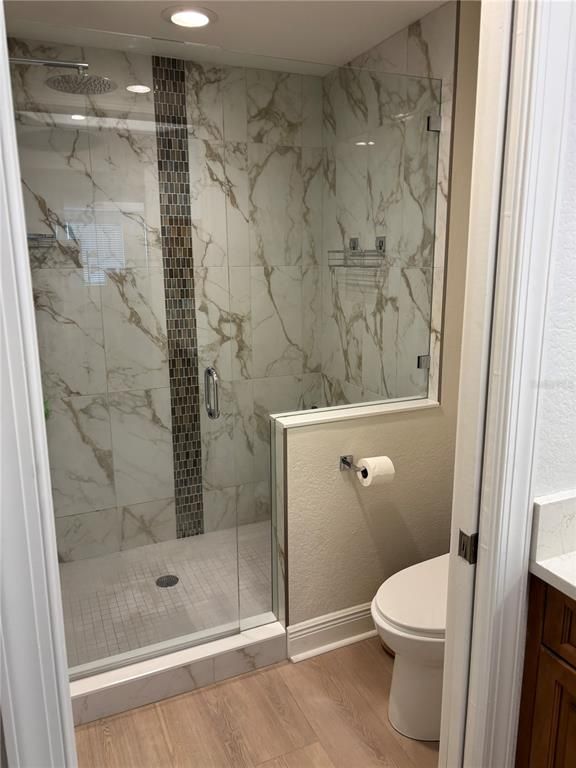 Bathroom, Glass Shower, Interior, Marble Walls, Recessed Lighting, Wood Texture Flooring