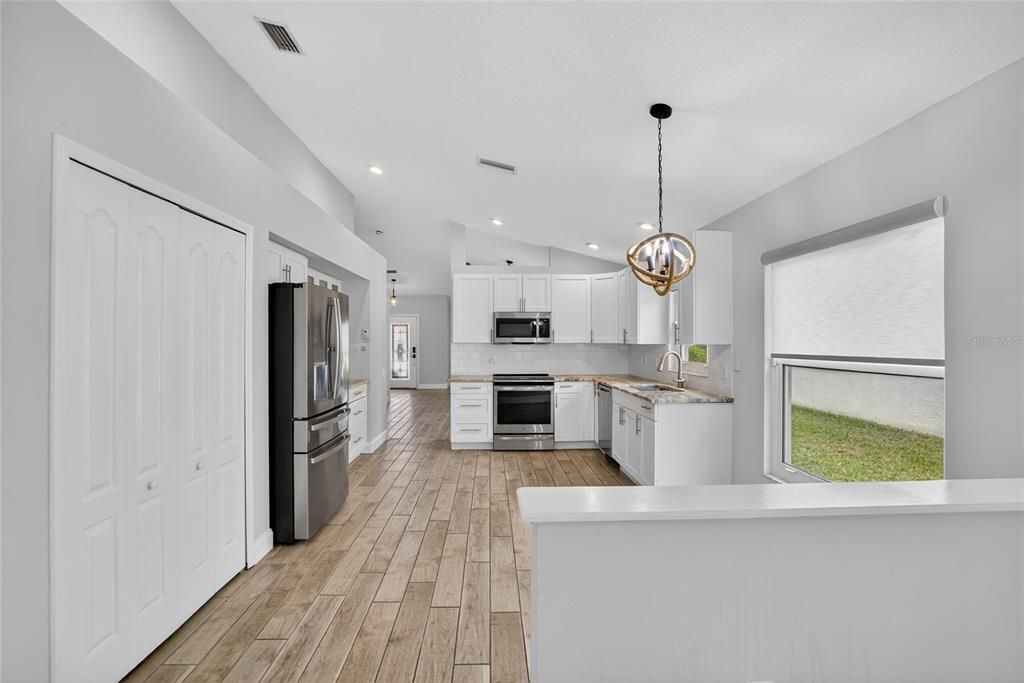 Chandelier, Interior, Kitchen, Pendant Lights, Recessed Lighting, Stainless Steel Appliances, Wood Texture Flooring