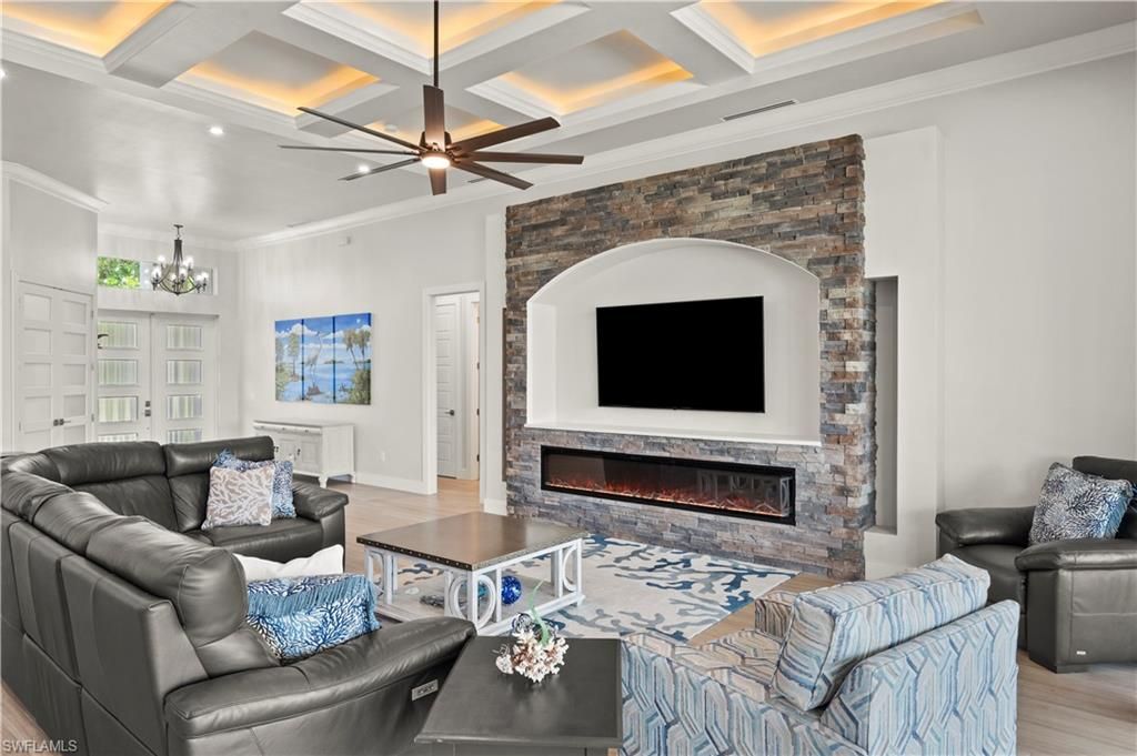 Chandelier, Fireplace, Interior, Living room, Recessed Lighting, Stone Walls, Wood Texture Flooring