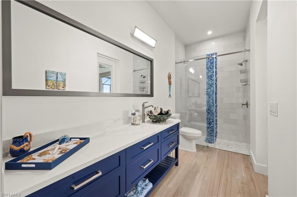 Bathroom, Dual Sink Vanities, Glass Shower, Interior, Recessed Lighting, Wood Texture Flooring