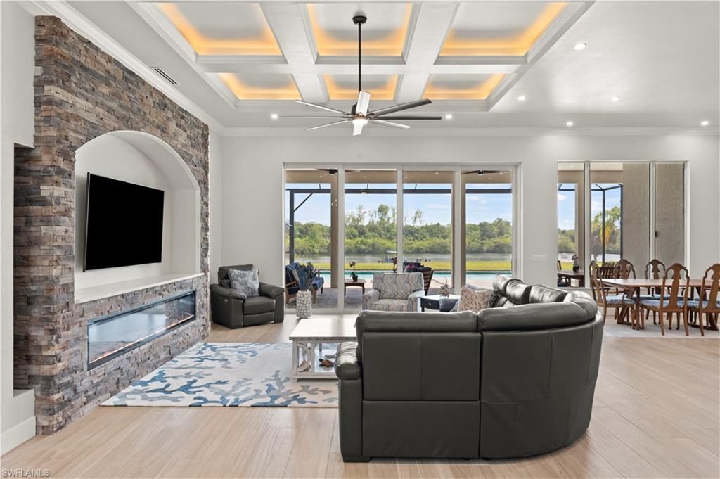 Dining room, Fireplace, Interior, Living room, Recessed Lighting, Stone Walls, Wood Texture Flooring