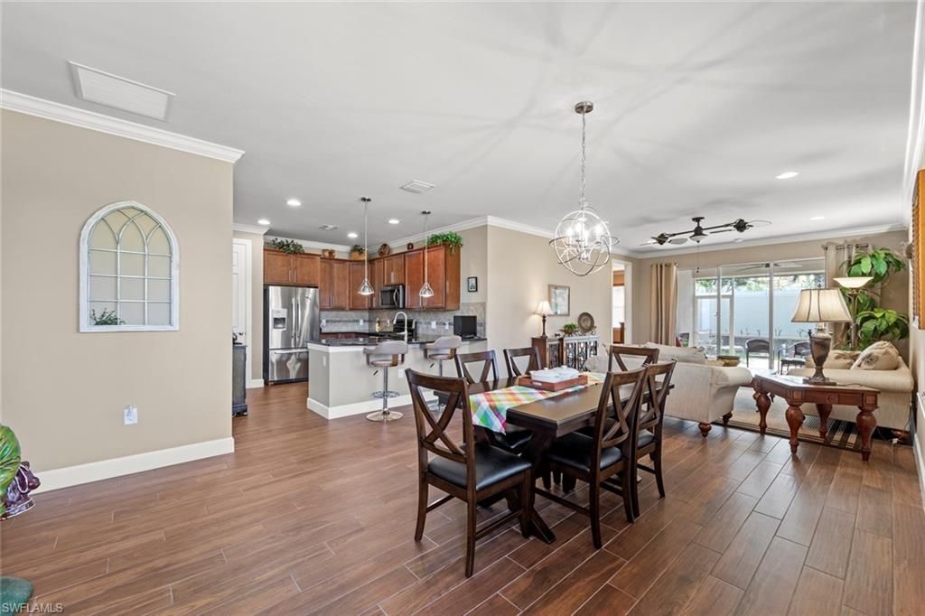 Chandelier, Dining room, Interior, Kitchen, Living room, Pendant Lights, Recessed Lighting, Stainless Steel Appliances, Wood Texture Flooring
