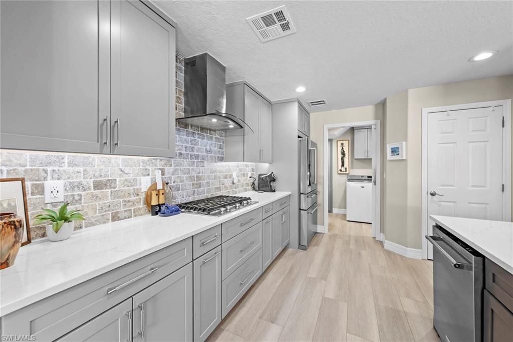 Interior, Kitchen, Recessed Lighting, Washer, Wood Texture Flooring