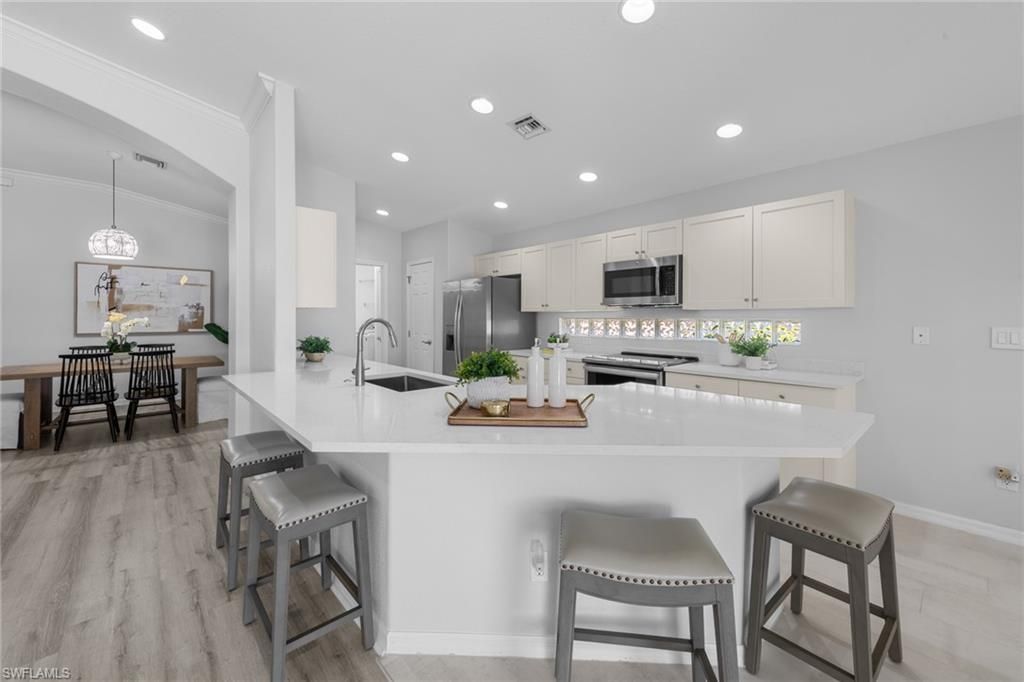 Dining room, Interior, Kitchen, Pendant Lights, Recessed Lighting, Stainless Steel Appliances, Wood Texture Flooring