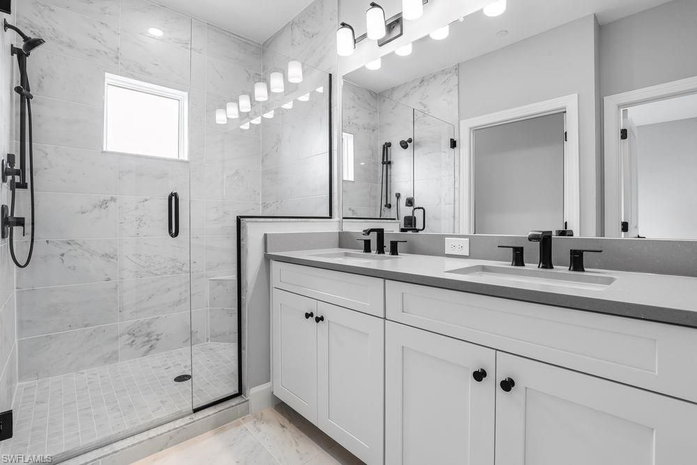 Bathroom, Dual Sink Vanities, Glass Shower, Interior, Marble Walls, Recessed Lighting