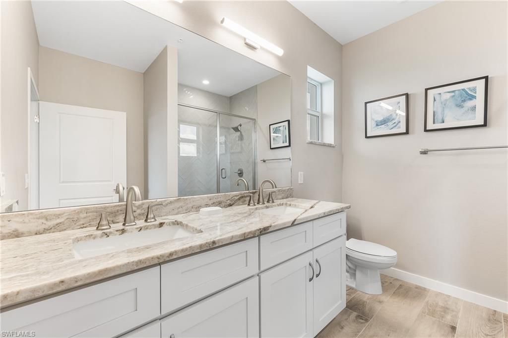 Bathroom, Dual Sink Vanities, Glass Shower, Interior, Recessed Lighting, Wood Texture Flooring
