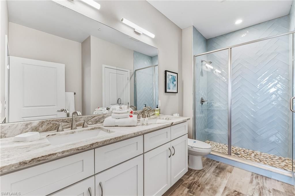 Bathroom, Dual Sink Vanities, Glass Shower, Interior, Recessed Lighting, Wood Texture Flooring