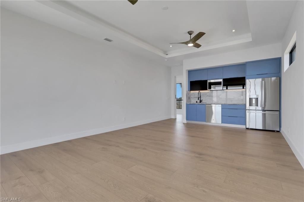 Empty room, Interior, Kitchen, Recessed Lighting, Stainless Steel Appliances, Wood Texture Flooring
