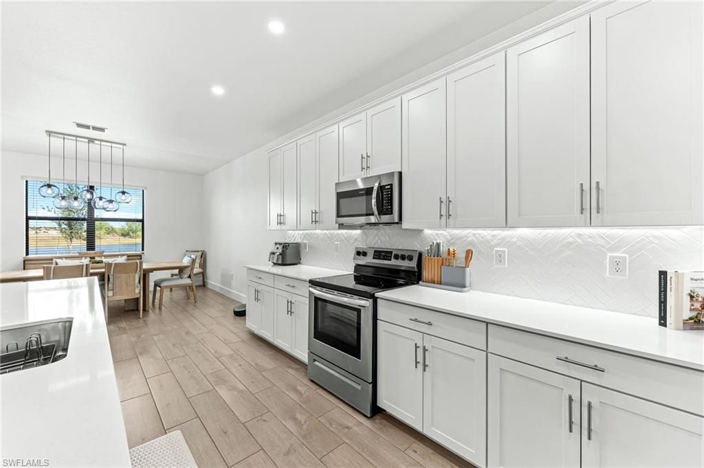 Dining room, Interior, Kitchen, Pendant Lights, Recessed Lighting, Stainless Steel Appliances, Wood Texture Flooring