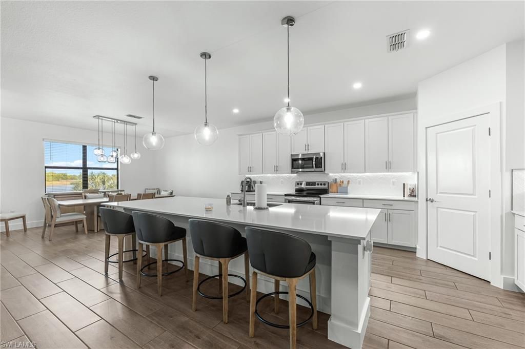 Dining room, Interior, Kitchen, Pendant Lights, Recessed Lighting, Stainless Steel Appliances, Wood Texture Flooring