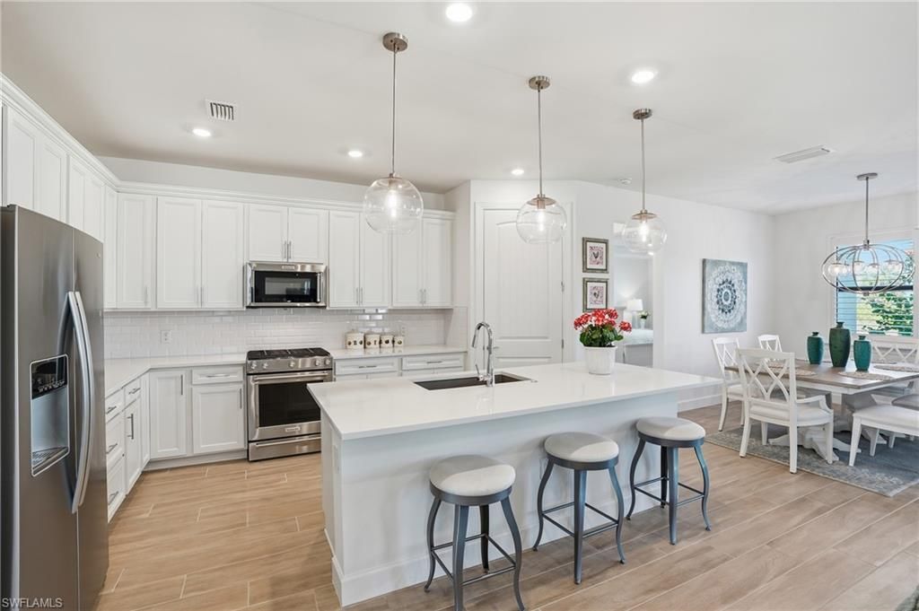 Dining room, Interior, Kitchen, Pendant Lights, Recessed Lighting, Stainless Steel Appliances, Wood Texture Flooring
