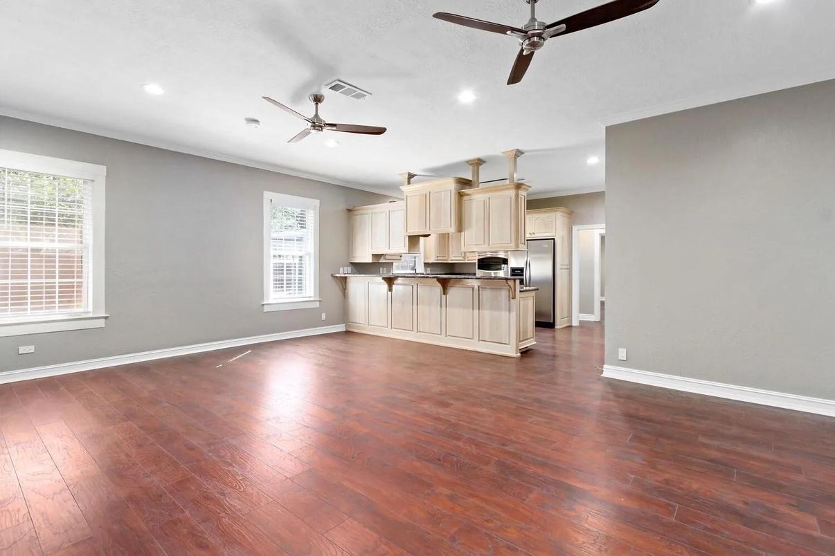 Empty room, Interior, Kitchen, Recessed Lighting, Stainless Steel Appliances, Wood Texture Flooring