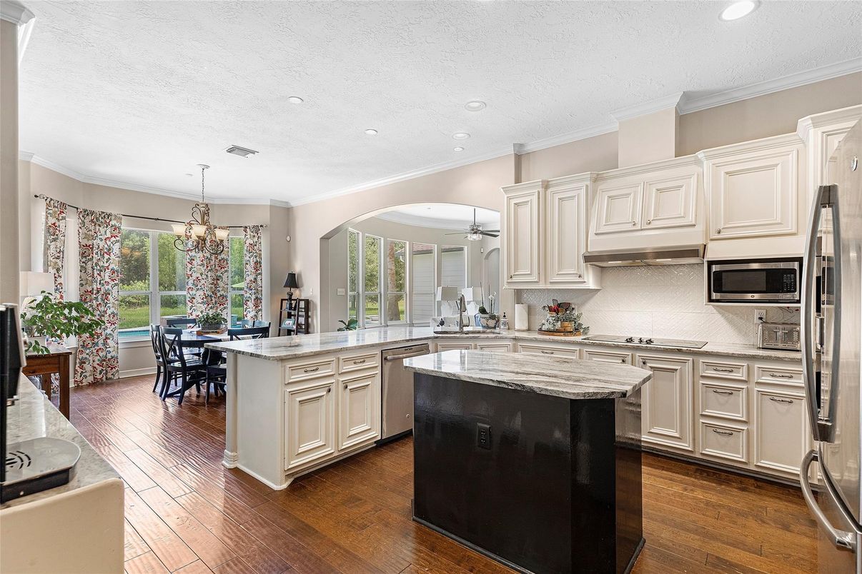 Chandelier, Dining room, Interior, Kitchen, Recessed Lighting, Stainless Steel Appliances, Wood Texture Flooring