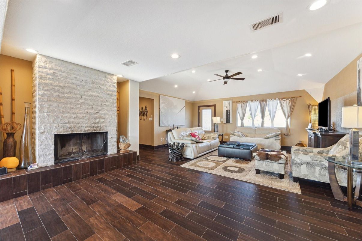 Fireplace, Interior, Living room, Recessed Lighting, Stone Walls, Wood Texture Flooring