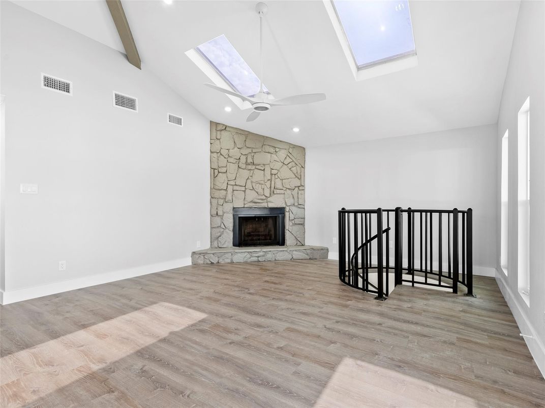 Empty room, Fireplace, Interior, Recessed Lighting, Stone Walls, Wood Texture Flooring