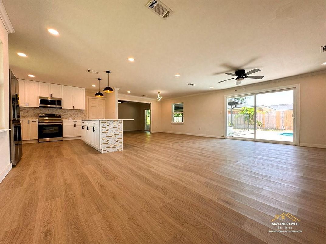 Empty room, Interior, Kitchen, Pendant Lights, Recessed Lighting, Stainless Steel Appliances, Wood Texture Flooring
