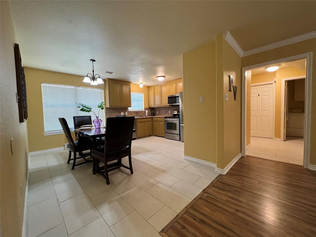 Chandelier, Dining room, Interior, Kitchen, Pendant Lights, Stainless Steel Appliances, Wood Texture Flooring