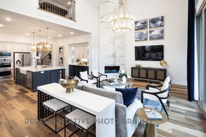 Chandelier, Dining room, Fireplace, Interior, Kitchen, Living room, Marble Walls, Pendant Lights, Recessed Lighting, Stainless Steel Appliances, Wood Texture Flooring