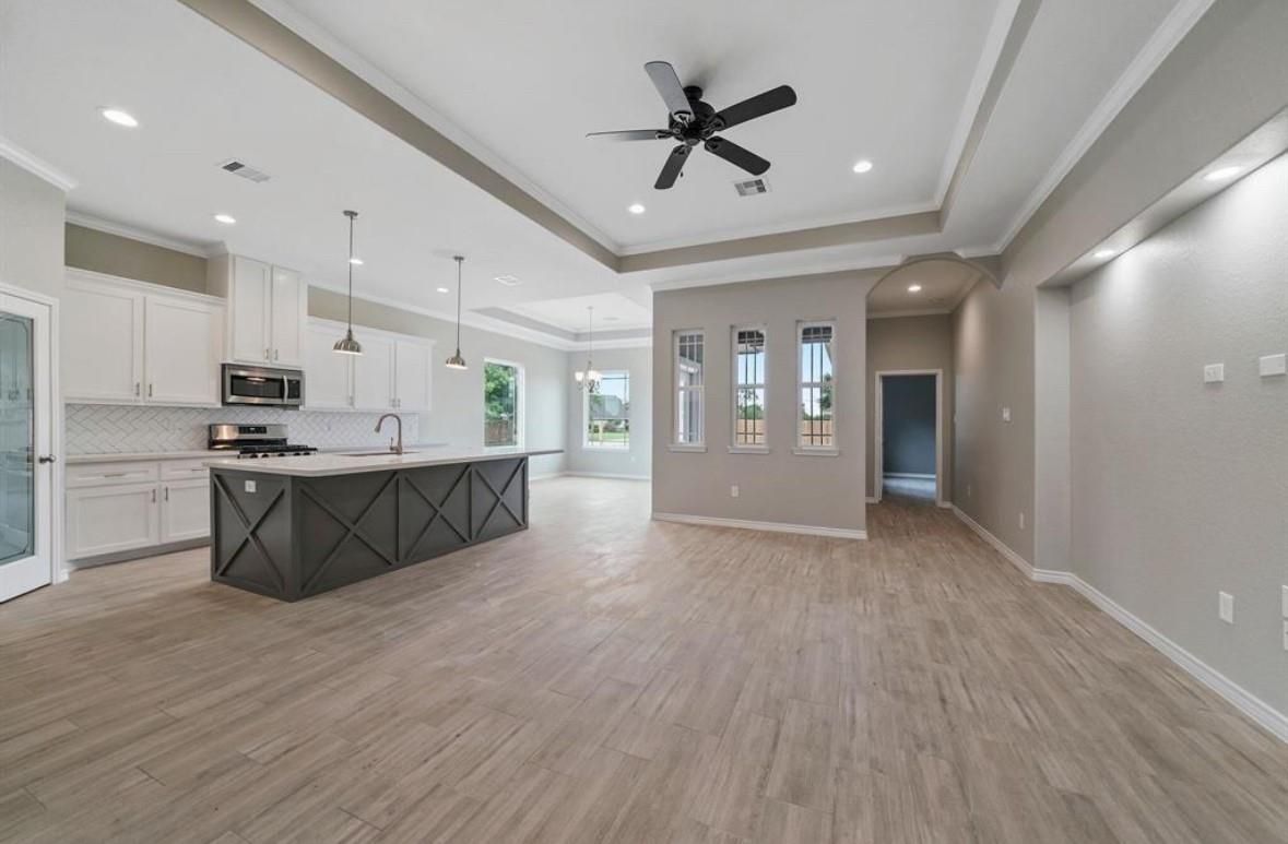 Empty room, Interior, Kitchen, Pendant Lights, Recessed Lighting, Stainless Steel Appliances, Wood Texture Flooring