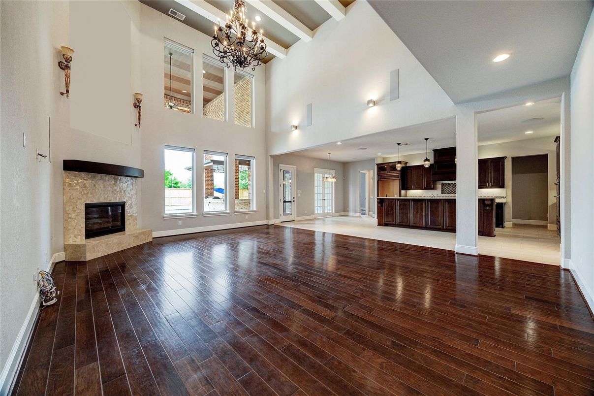 Chandelier, Empty room, Fireplace, Interior, Kitchen, Recessed Lighting, Wood Texture Flooring