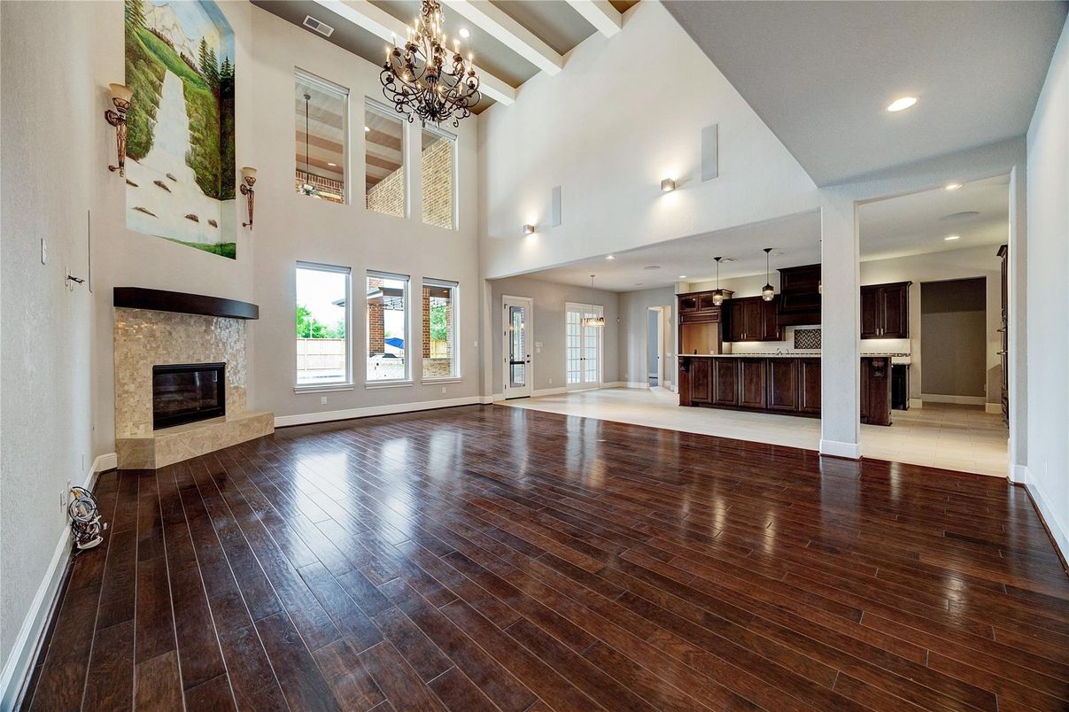 Chandelier, Empty room, Fireplace, Interior, Kitchen, Recessed Lighting, Wood Texture Flooring
