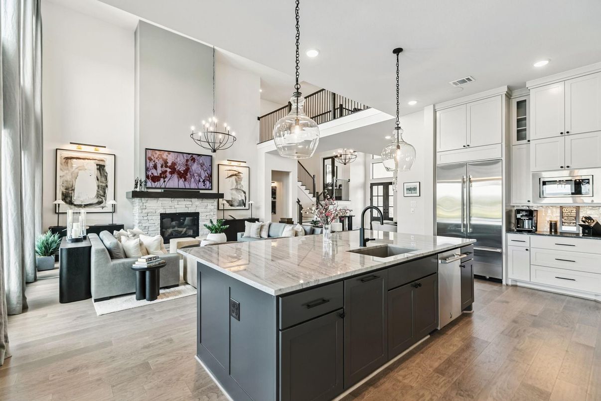 Chandelier, Fireplace, Interior, Kitchen, Living room, Pendant Lights, Recessed Lighting, Stainless Steel Appliances, Wood Texture Flooring