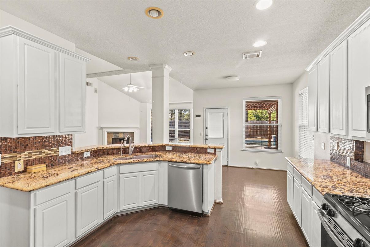 Fireplace, Interior, Kitchen, Recessed Lighting, Stainless Steel Appliances, Wood Texture Flooring