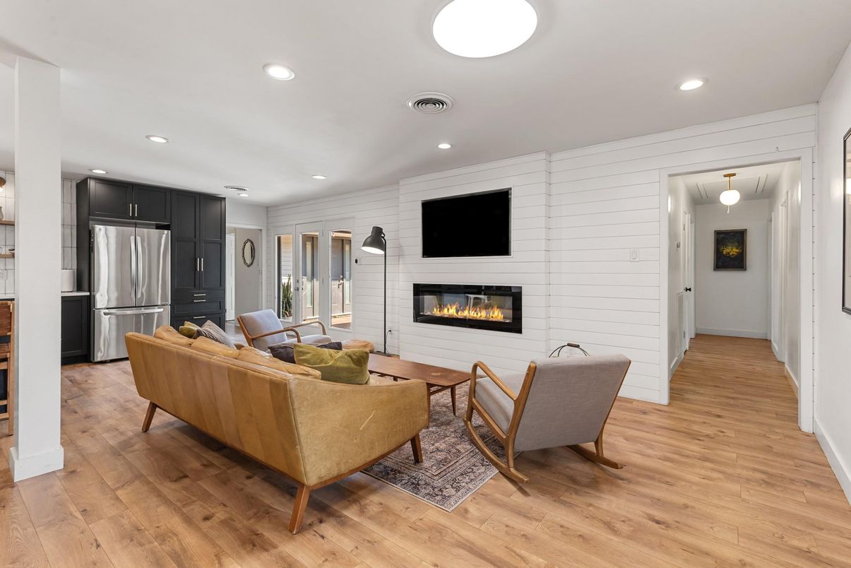 Fireplace, Interior, Kitchen, Living room, Recessed Lighting, Stainless Steel Appliances, Stone Walls, Wood Texture Flooring