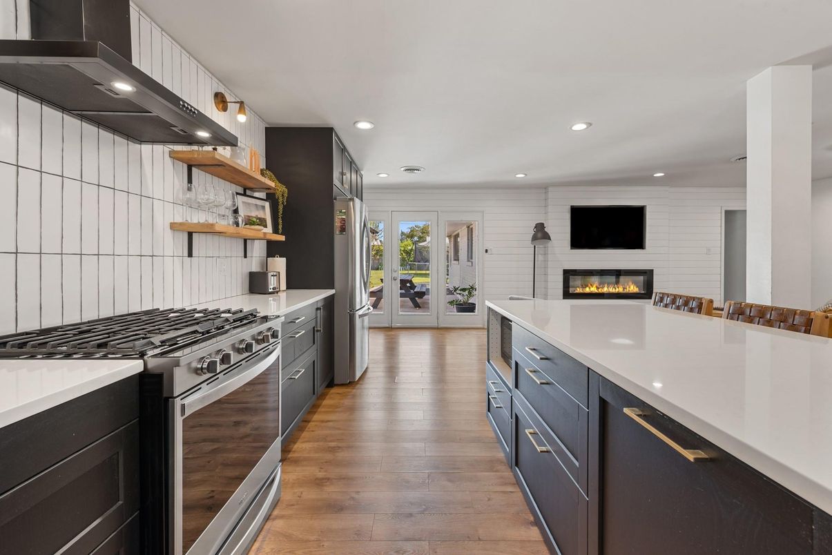 Fireplace, Interior, Kitchen, Recessed Lighting, Stainless Steel Appliances, Wood Texture Flooring