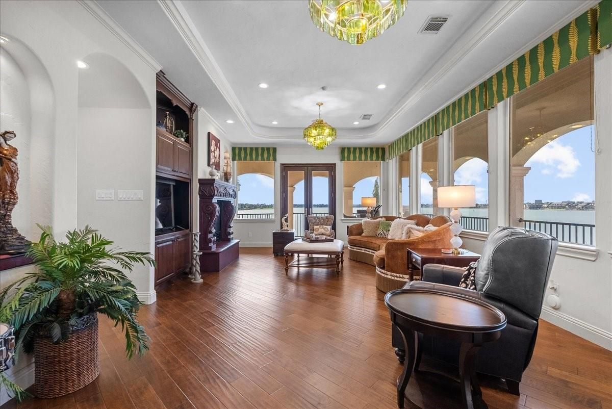 Chandelier, Fireplace, Interior, Living room, Recessed Lighting, Water, Wood Texture Flooring