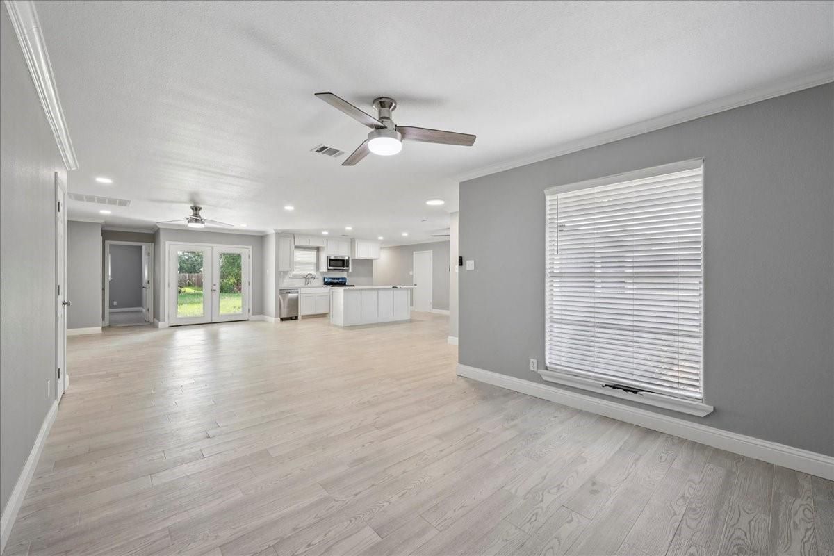 Empty room, Interior, Kitchen, Recessed Lighting, Stainless Steel Appliances, Wood Texture Flooring