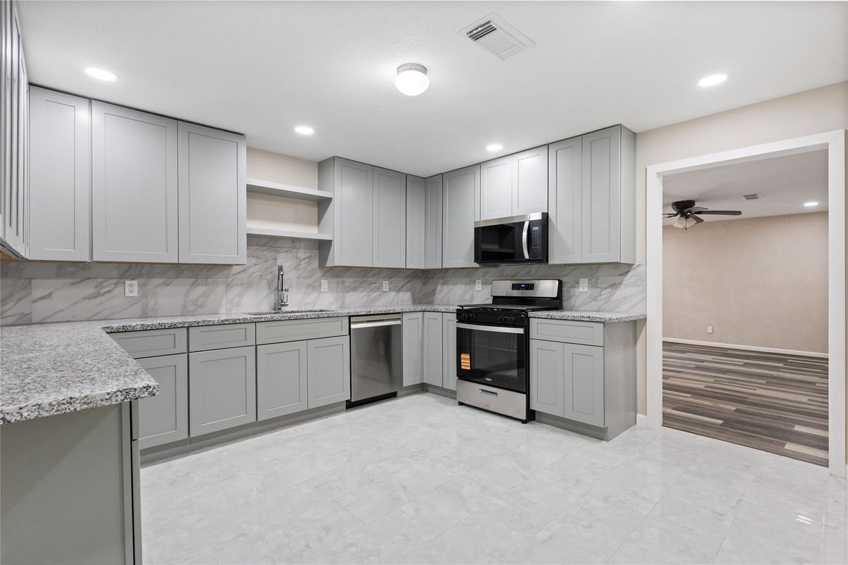 Interior, Kitchen, Marble Walls, Recessed Lighting, Stainless Steel Appliances, Wood Texture Flooring