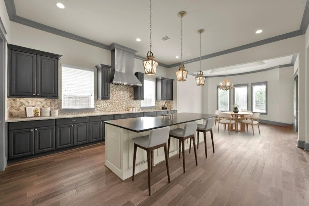 Chandelier, Dining room, Interior, Kitchen, Pendant Lights, Recessed Lighting, Stainless Steel Appliances, Wood Texture Flooring