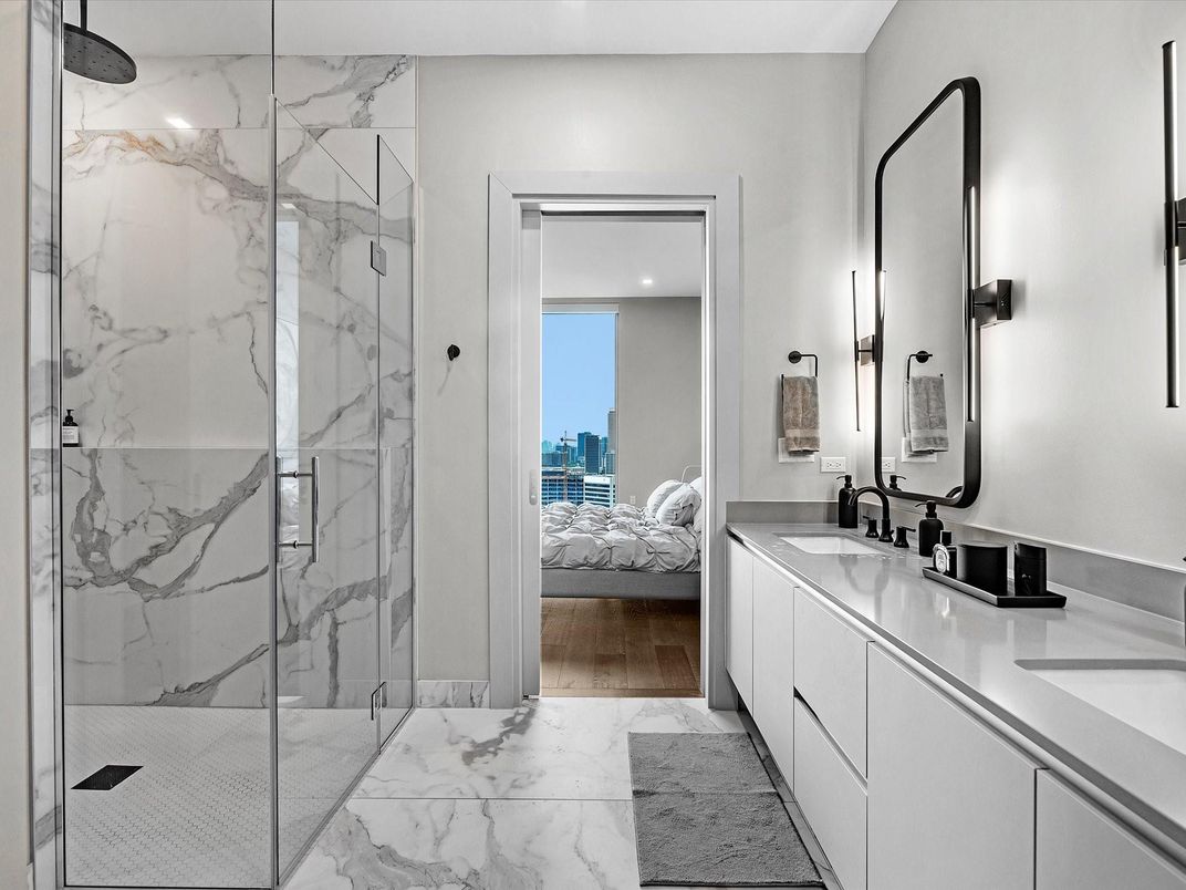 Bathroom, Bedroom, Dual Sink Vanities, Glass Shower, Interior, Marble, Marble Walls, Recessed Lighting, Water, Wood Texture Flooring